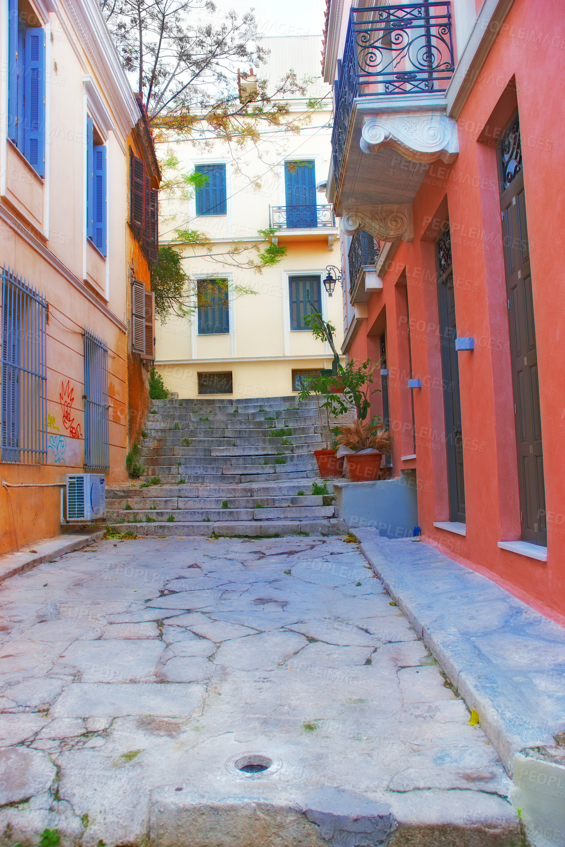 Buy stock photo View of an empty street alley between city buildings abroad in Germany. Narrow concrete road, stone steps in an old small overseas village. Exploring town and enjoying holiday and vacation in Europe