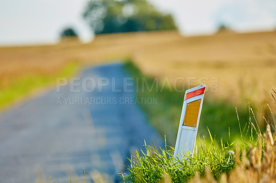 Buy stock photo Reflector, marker and road for travel outdoor in nature for vehicle guide, direction and safety in countryside. Street, environment and post with transport navigation, visual hazards and traffic path