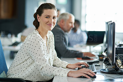 Buy stock photo Portrait of a young woman working at her computer in an office