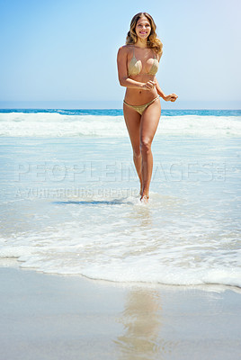Buy stock photo Portrait of a beautiful young woman running through the water at the beach