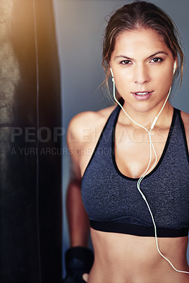 Buy stock photo Portrait, woman and boxer with workout, punching bag or exercise for wellness or challenge grey background. Earphones, athlete or healthy girl in gym, fitness or audio with energy or listen to music