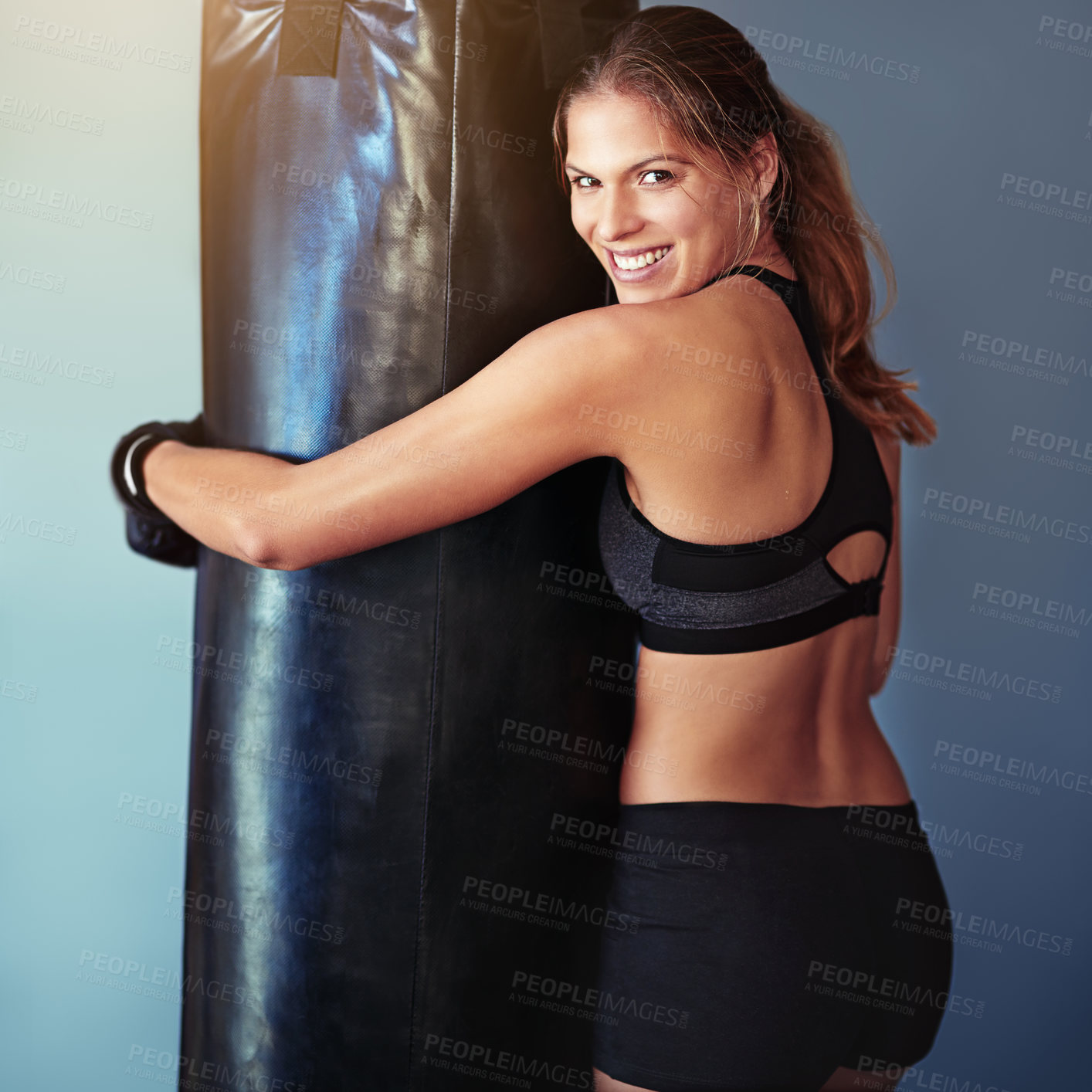 Buy stock photo Portrait, woman and boxer with punching bag, wellness or exercise for health, challenge and sports on grey background. Club, athlete and healthy girl in gym, workout and fighter with energy and smile