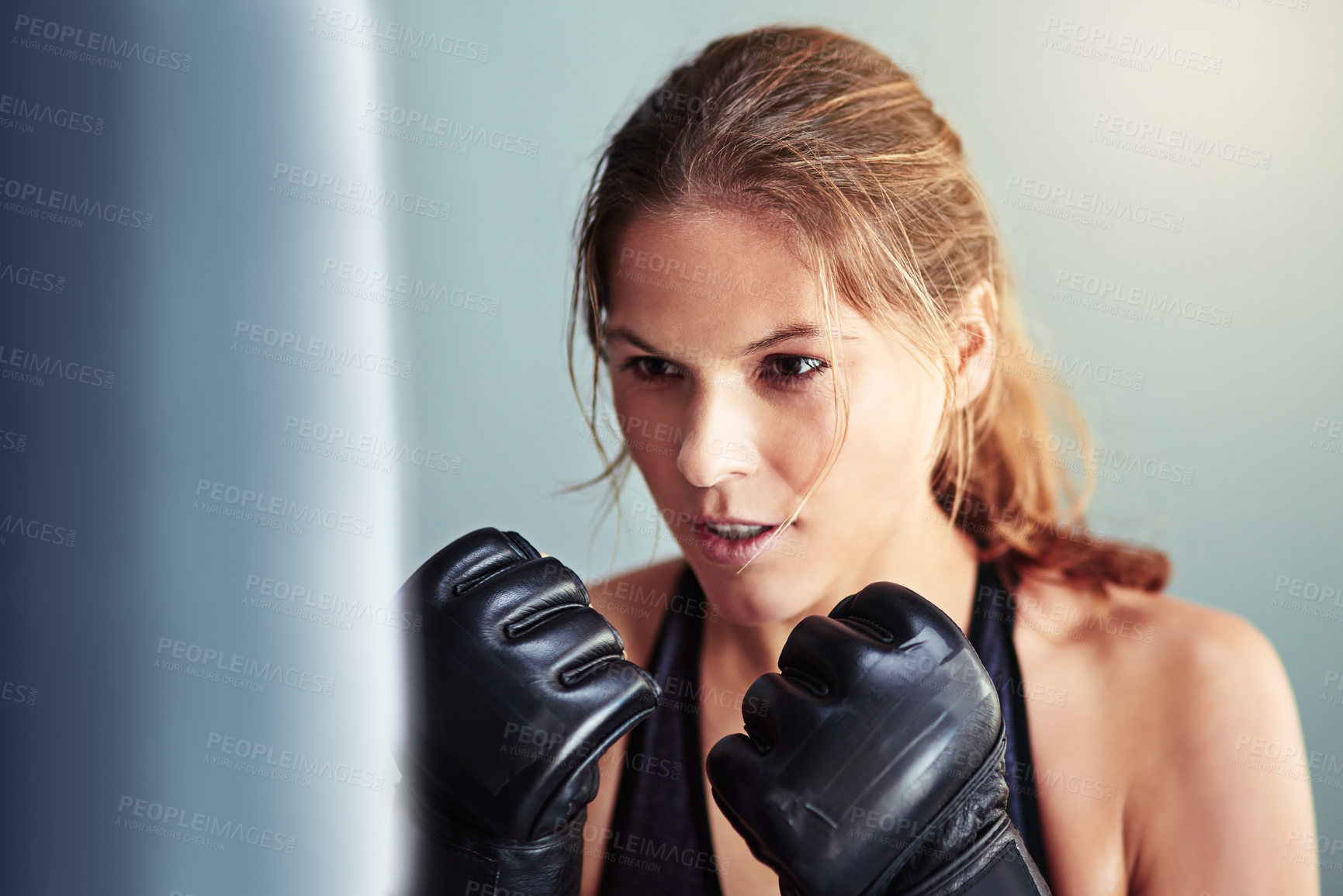 Buy stock photo Woman, punching bag and boxer in gym for training, mma and gloves for competition, sports and fitness. Person, athlete and ready for martial arts, exercise and workout for combat, fight and contest