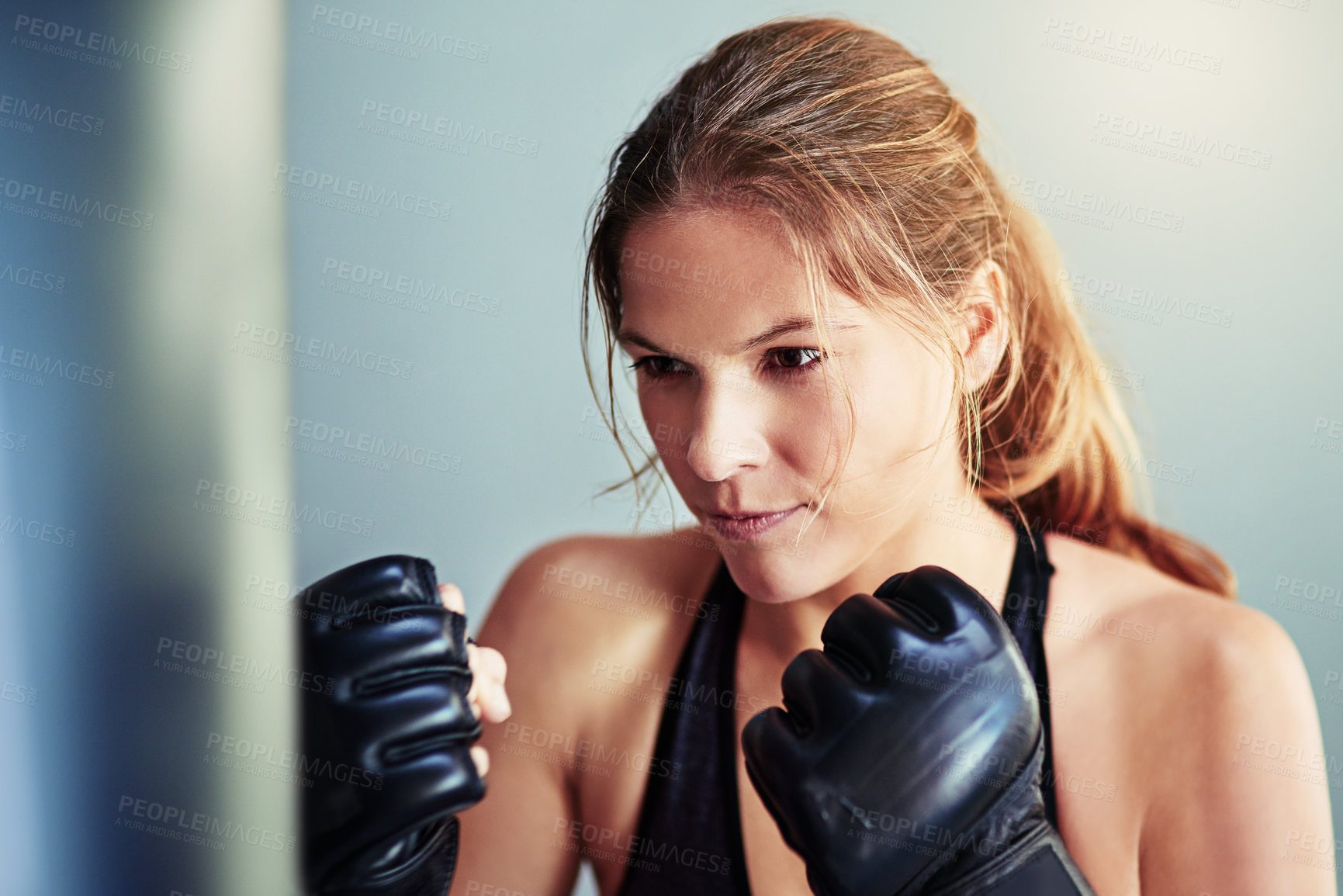 Buy stock photo Woman, punching bag and boxer in gym for workout, mma and gloves for competition, sports and fitness. Person, happy and ready for martial arts, exercise and training for combat, fight or contest