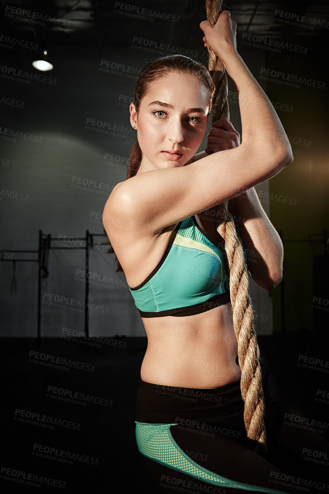 Buy stock photo Woman climbing rope, exercise and portrait in gym with action and energy, fitness and healthy active person. Strong, power and muscle training with young female athlete, workout for health and sport