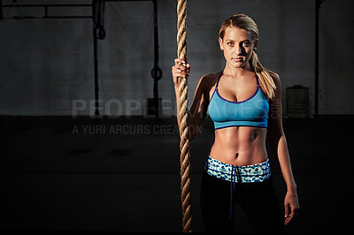 Buy stock photo Shot of a young woman doing rope climbing