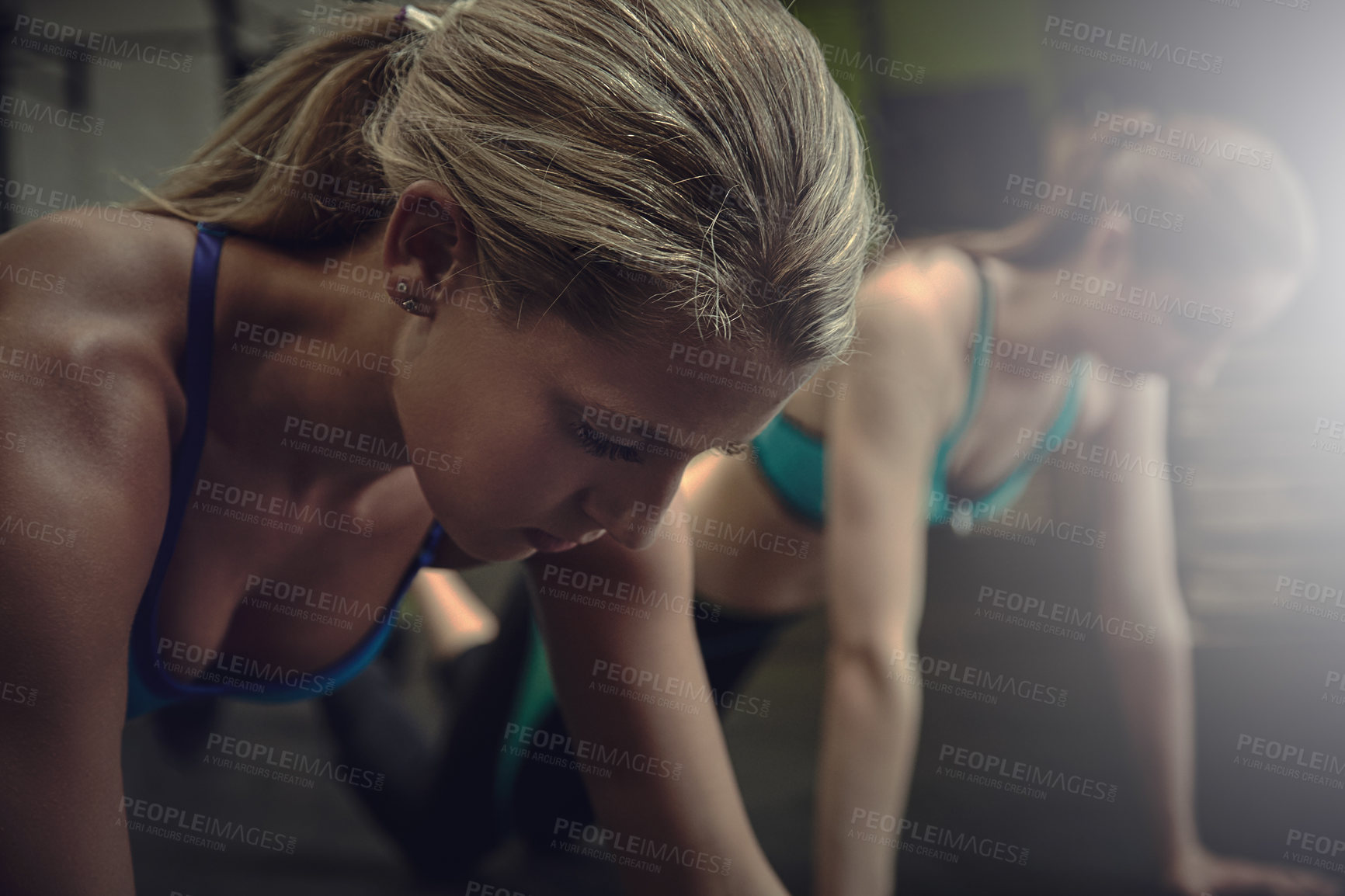 Buy stock photo Shot of two young women doing pushups