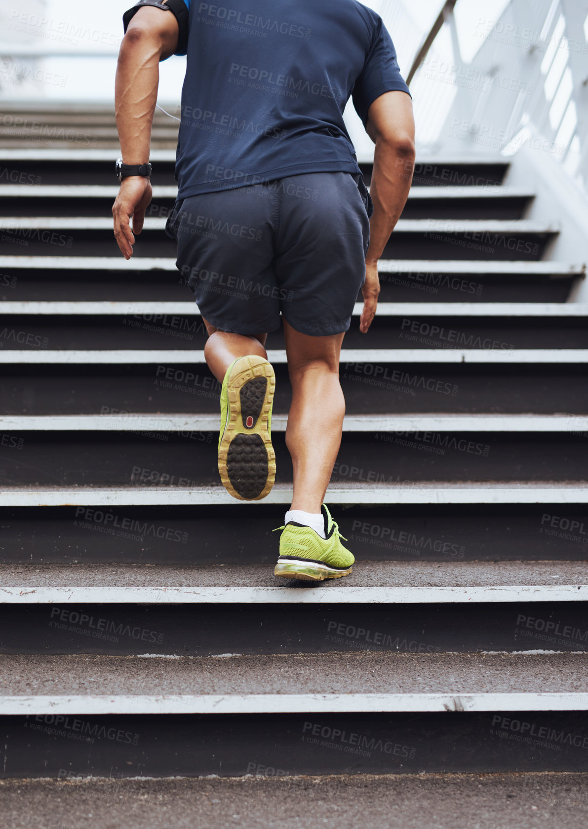 Buy stock photo Cropped shot of a sporty young man running up steps