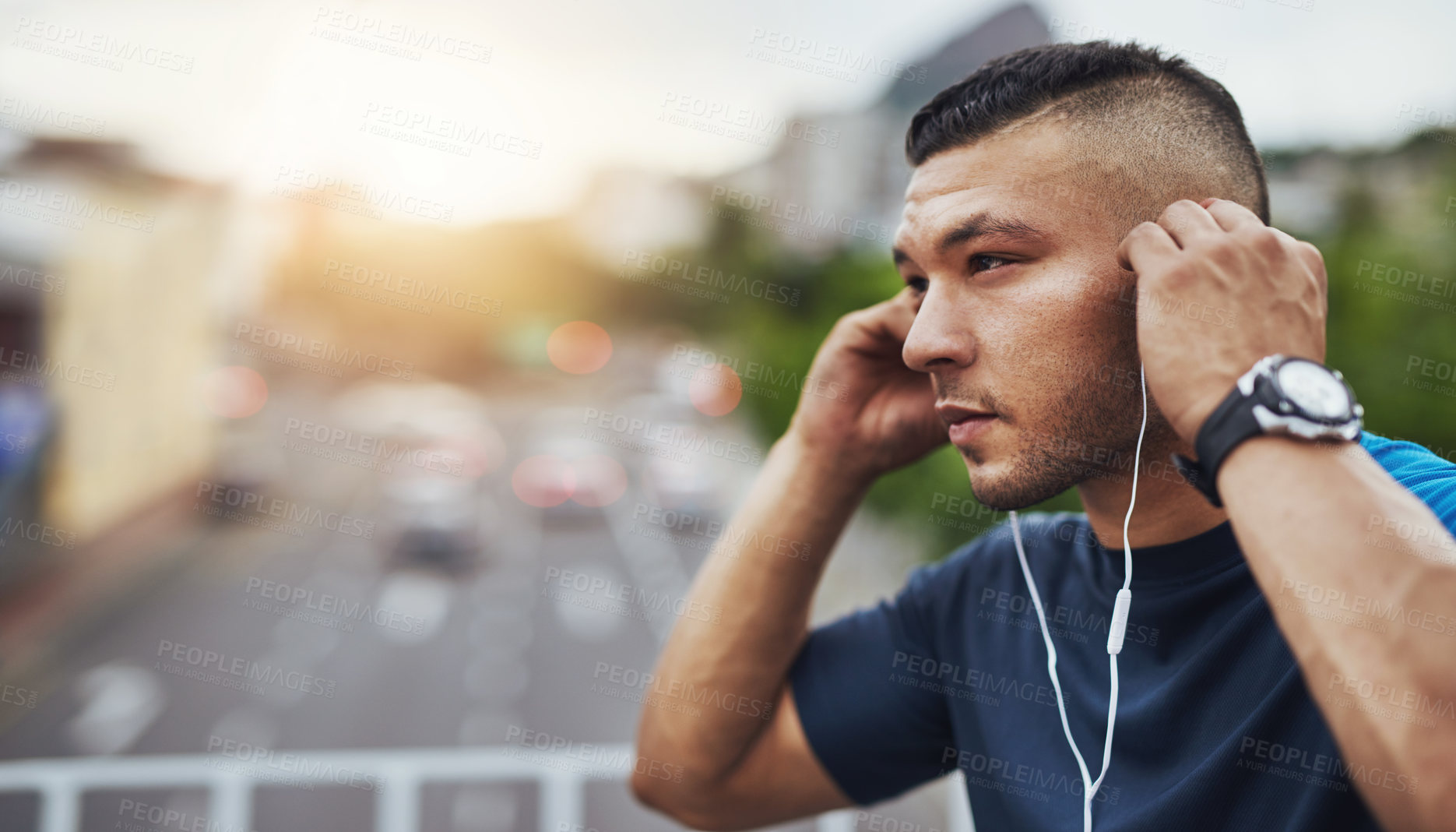 Buy stock photo Shot of a young man out for a run in the city