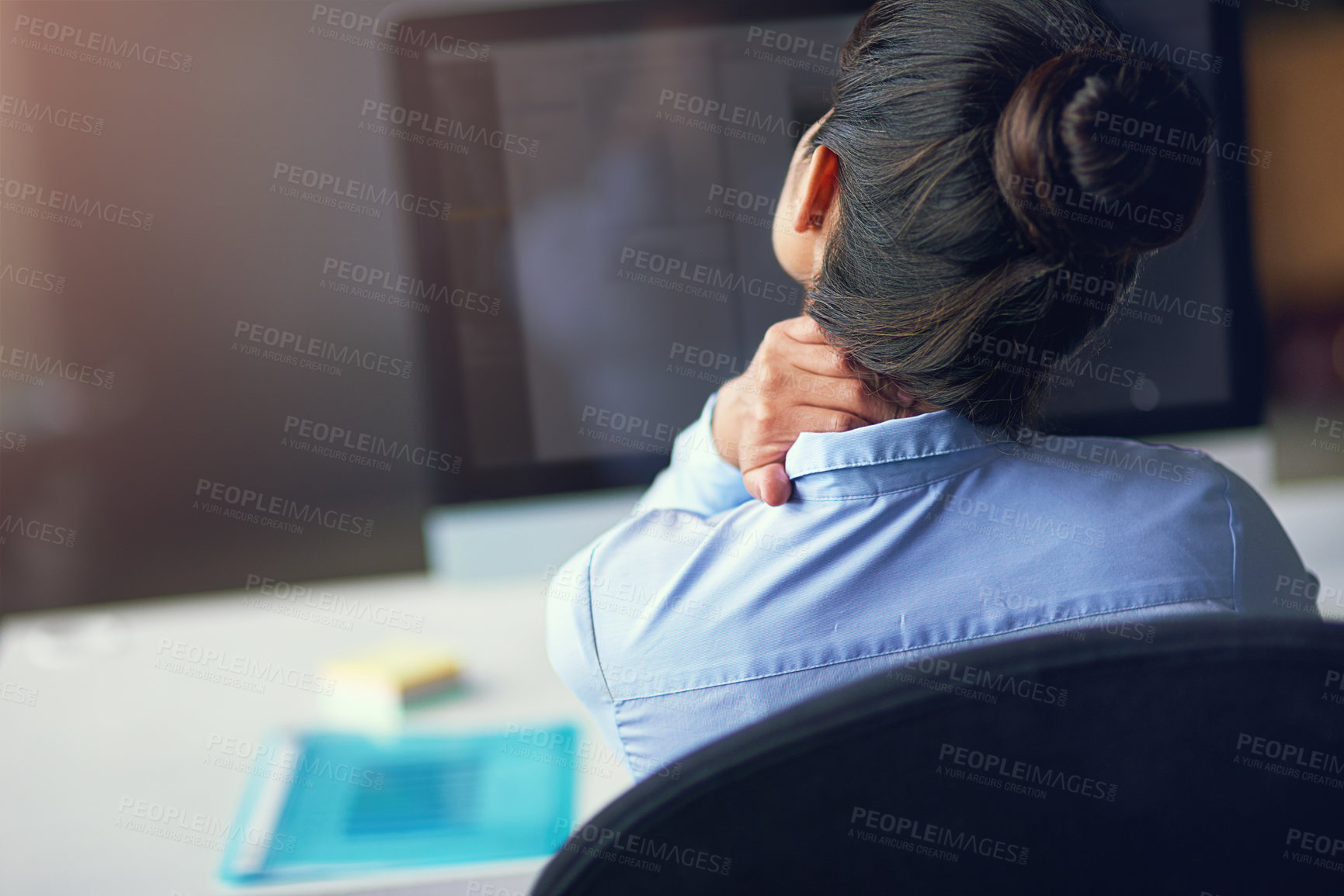 Buy stock photo Rearview shot of a businesswoman suffering from neck pain at the office