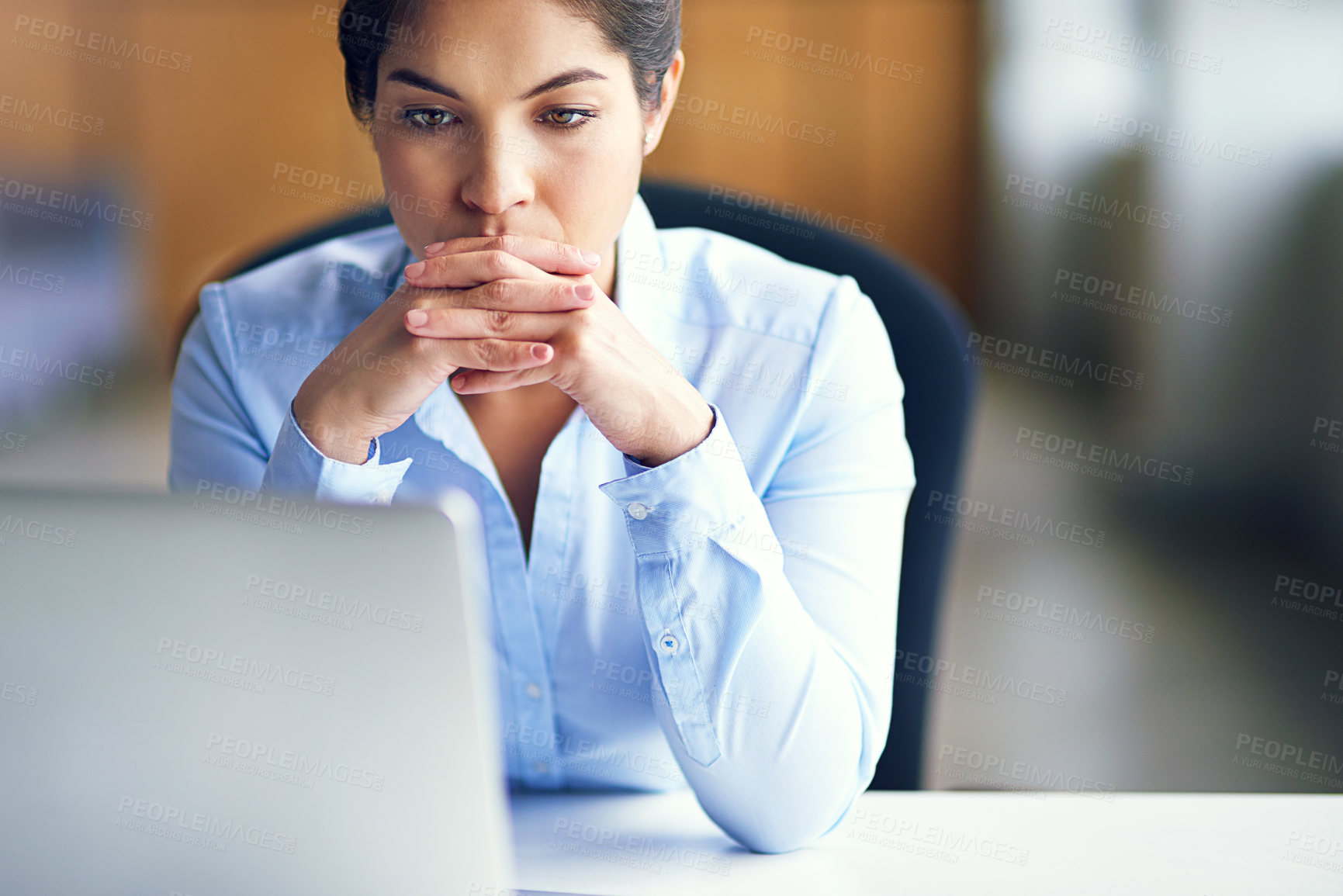 Buy stock photo Shot of a young businesswoman looking stressed while working at her desk