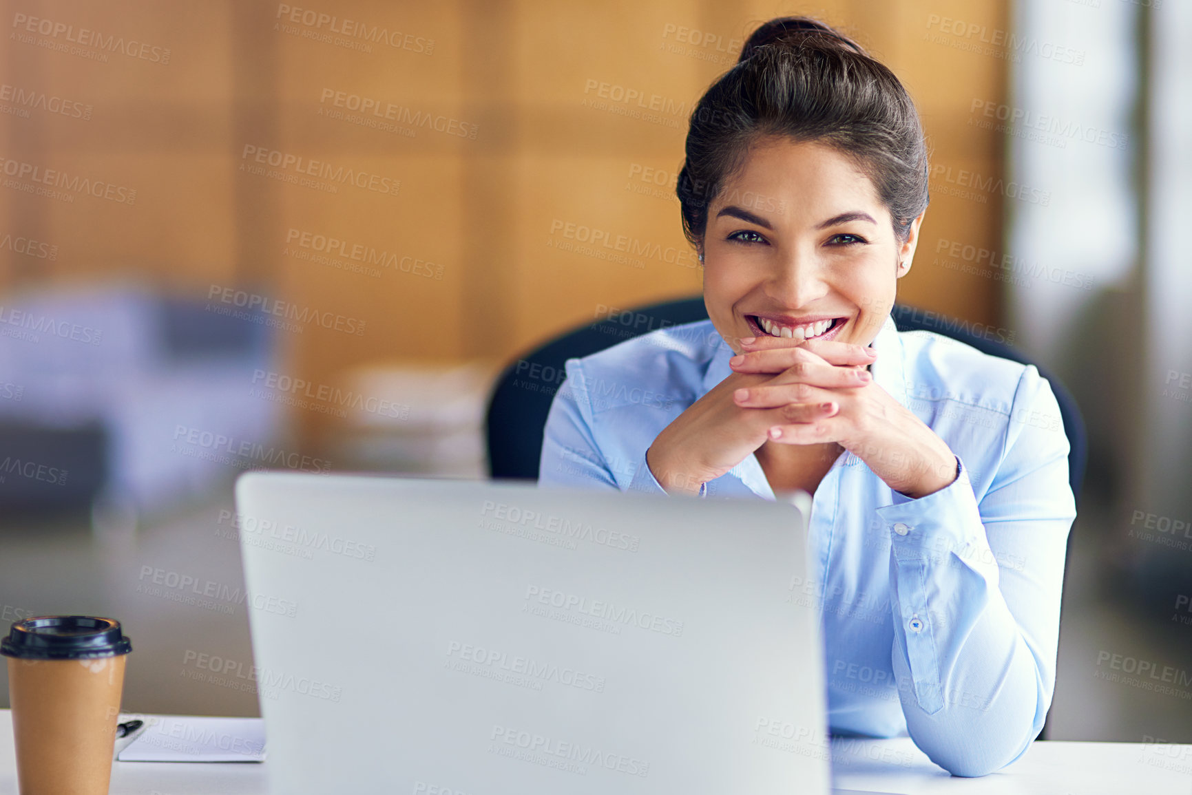 Buy stock photo Portrait of a young businesswoman sitting with her laptop in the office