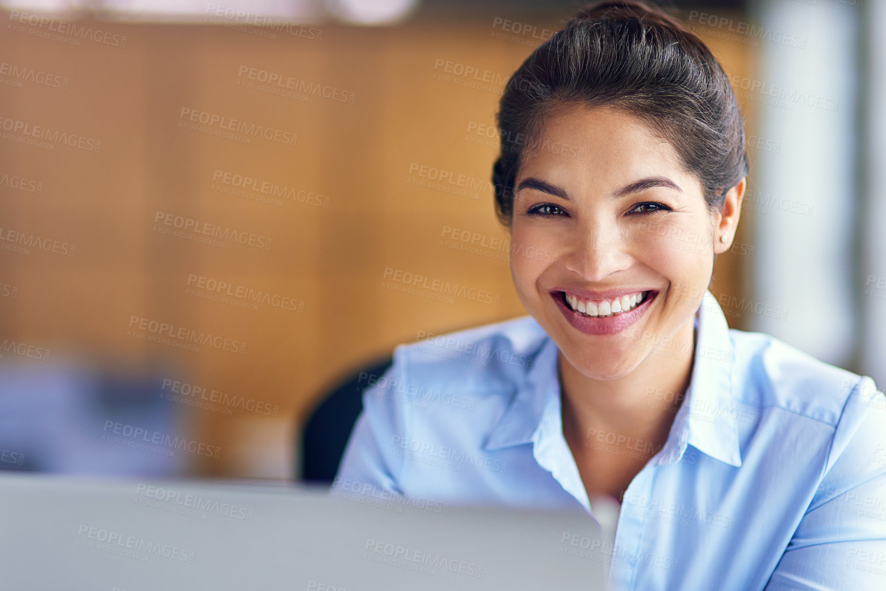 Buy stock photo Cropped portrait of a young businesswoman working on her laptop in the office