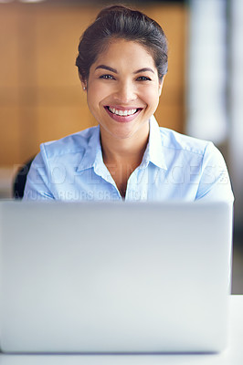 Buy stock photo Portrait of a young businesswoman working on her laptop in the office