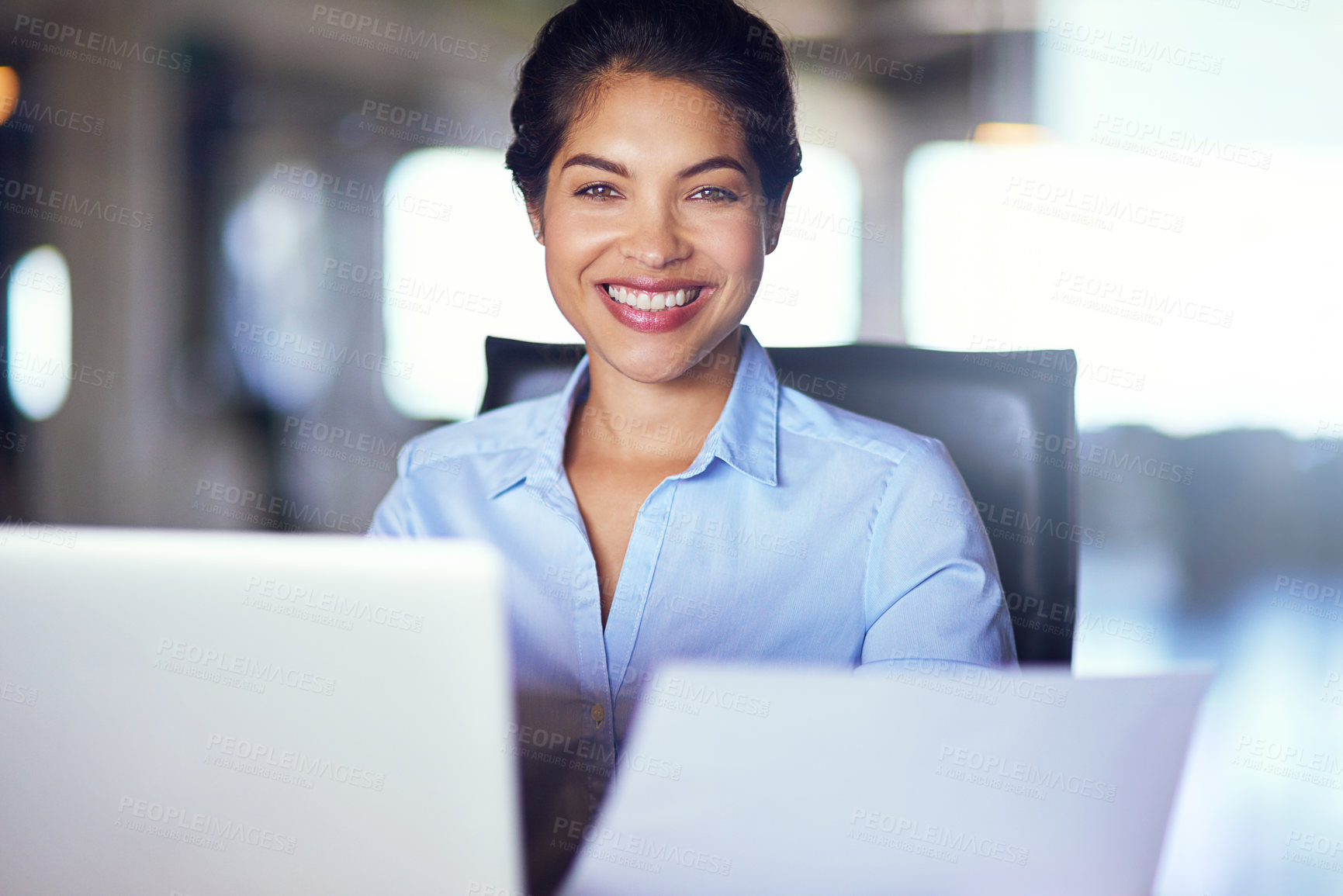 Buy stock photo Portrait of a young businesswoman working on her laptop in the office