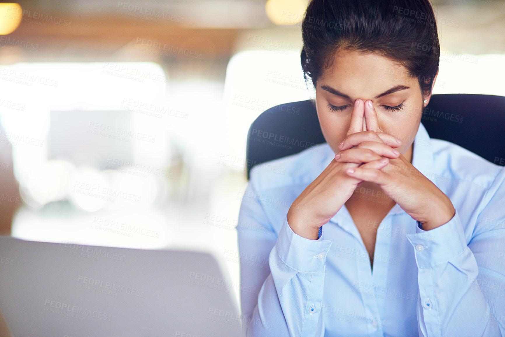 Buy stock photo Shot of a young businesswoman looking stressed while sitting at her desk