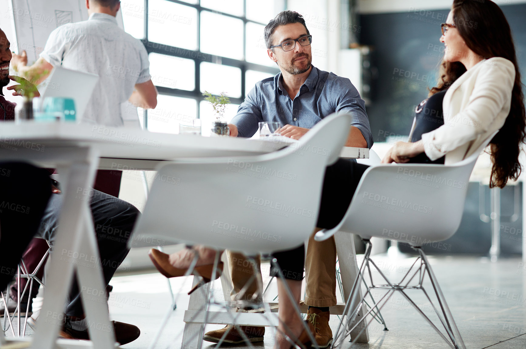 Buy stock photo Shot of a group of businesspeople meeting in the boardroom