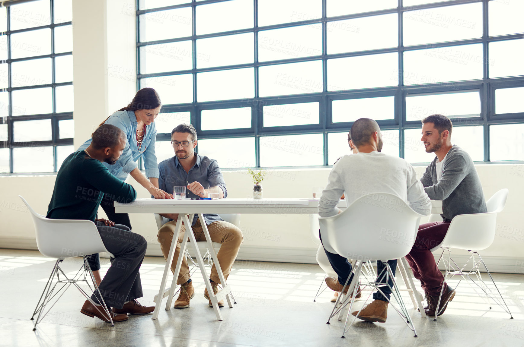 Buy stock photo Shot of a group of coworkers having a meeting in an open plan office