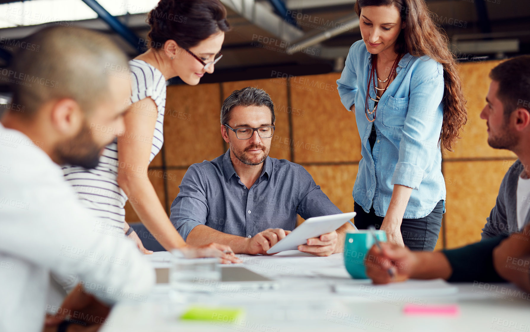 Buy stock photo Shot of a group of coworkers having a meeting in an open plan office