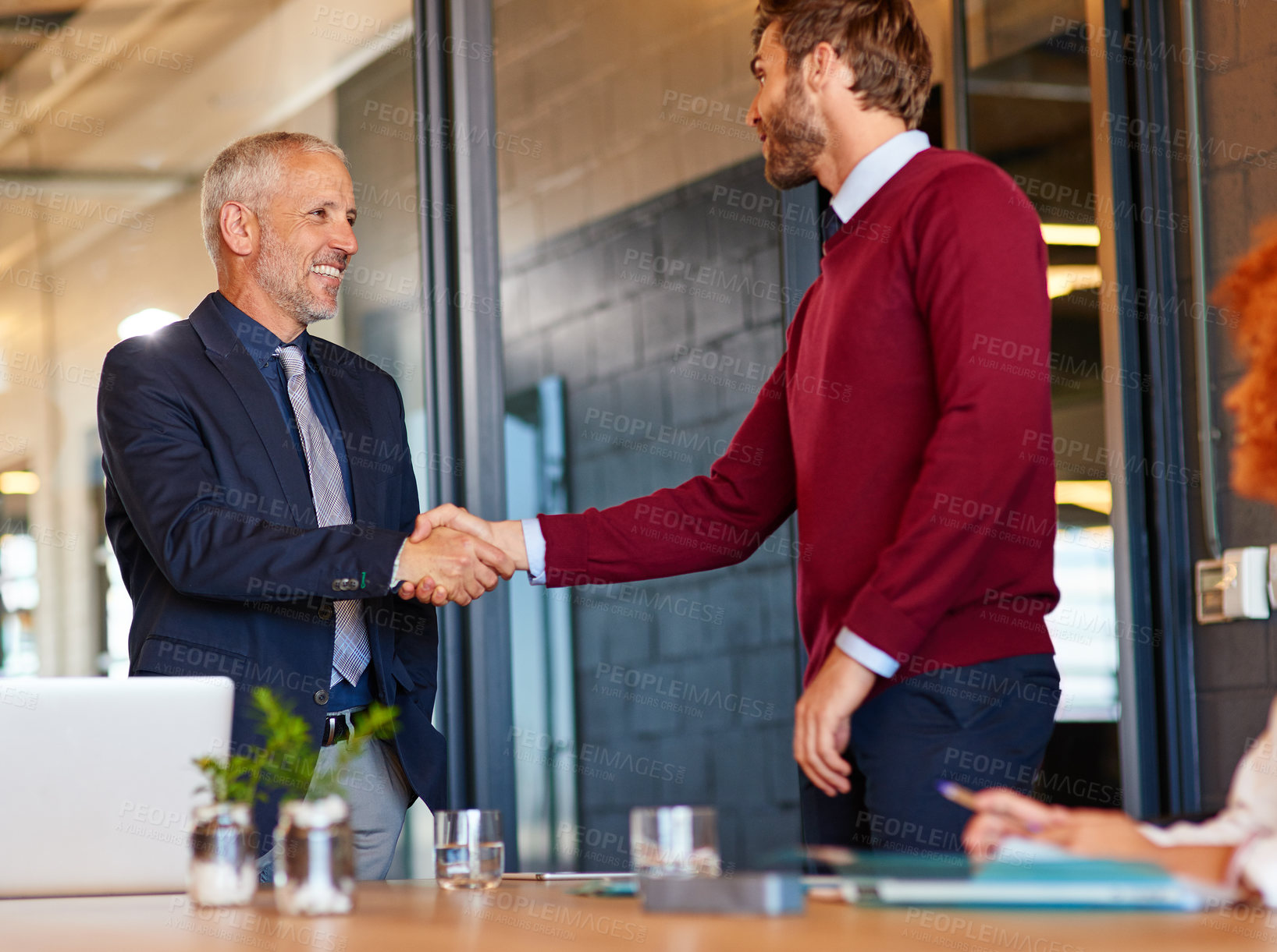 Buy stock photo Shot of two businessmen shaking hands in an office