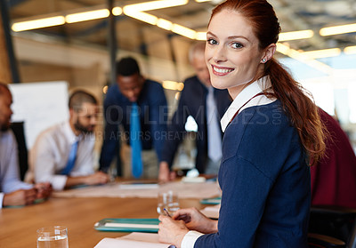 Buy stock photo Portrait of a young businesswoman with her colleagues in the background