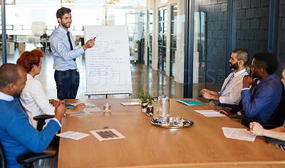 Buy stock photo Shot of a businessman doing a presentation during a boardroom meeting