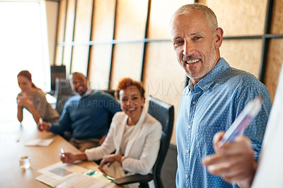 Buy stock photo Shot of a mature businessman delivering a presentation during a boardroom meeting