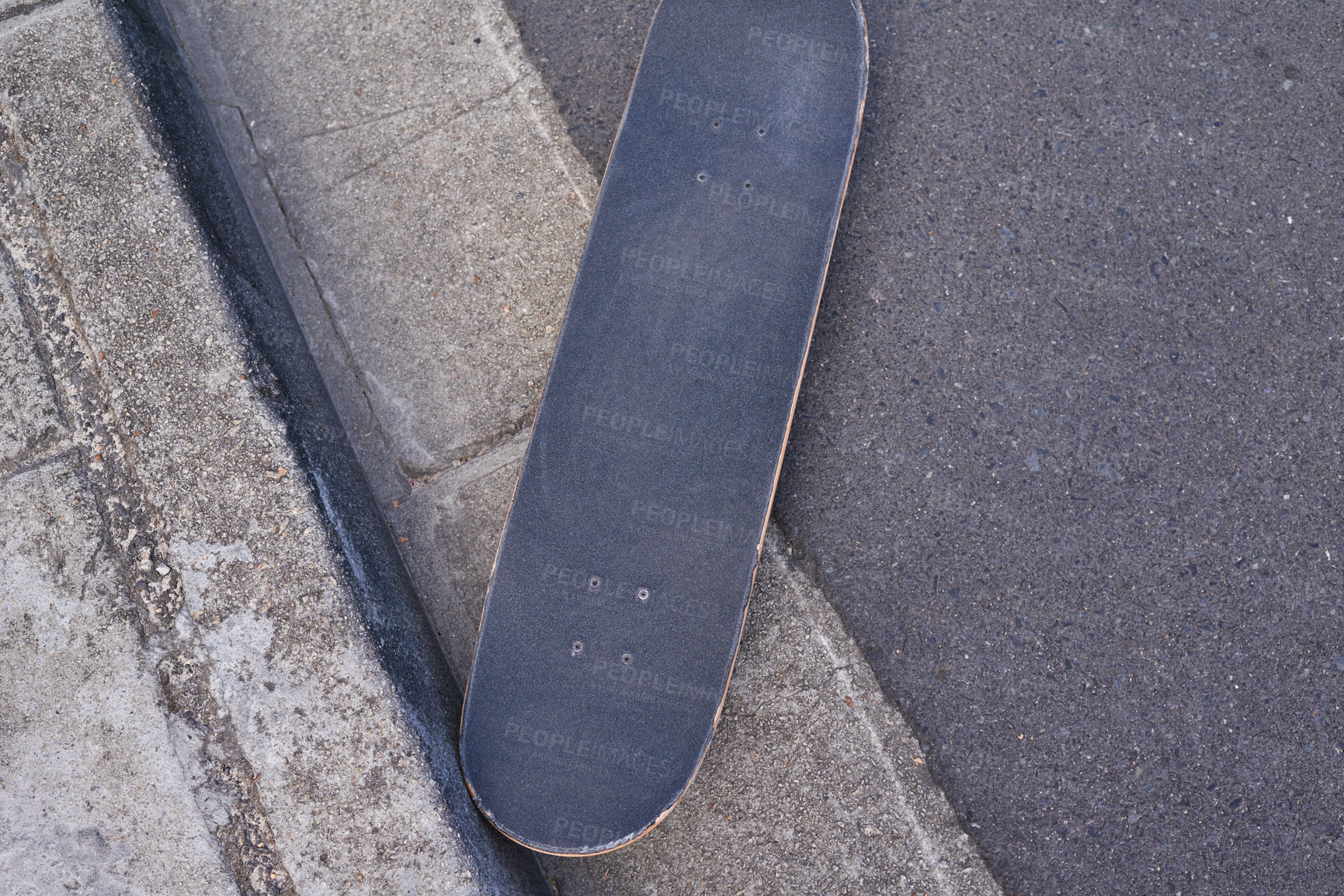 Buy stock photo Shot of a young man skateboarding through the city