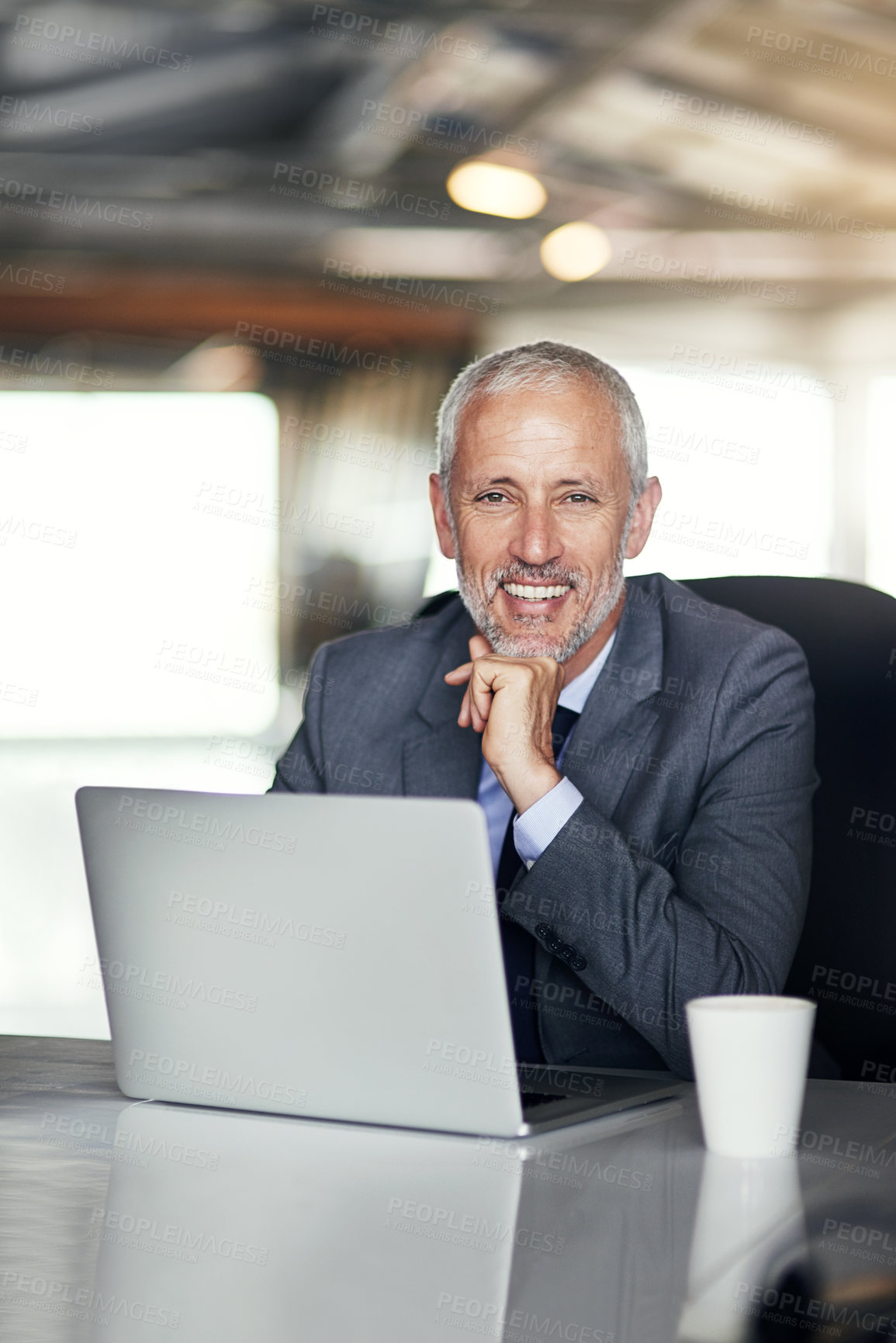 Buy stock photo Cropped portrait of a mature businessman working in his office