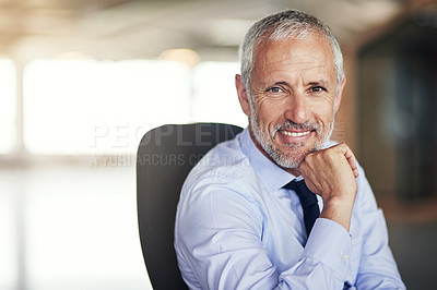 Buy stock photo Cropped portrait of a mature businessman sitting in his office