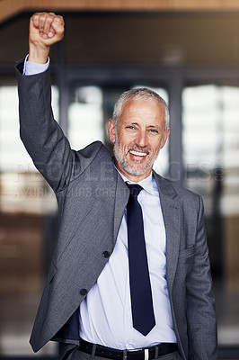 Buy stock photo Cropped portrait of a mature businessman standing with his hand raised in celebration