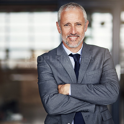 Buy stock photo Cropped portrait of a mature businessman standing with his arms folded