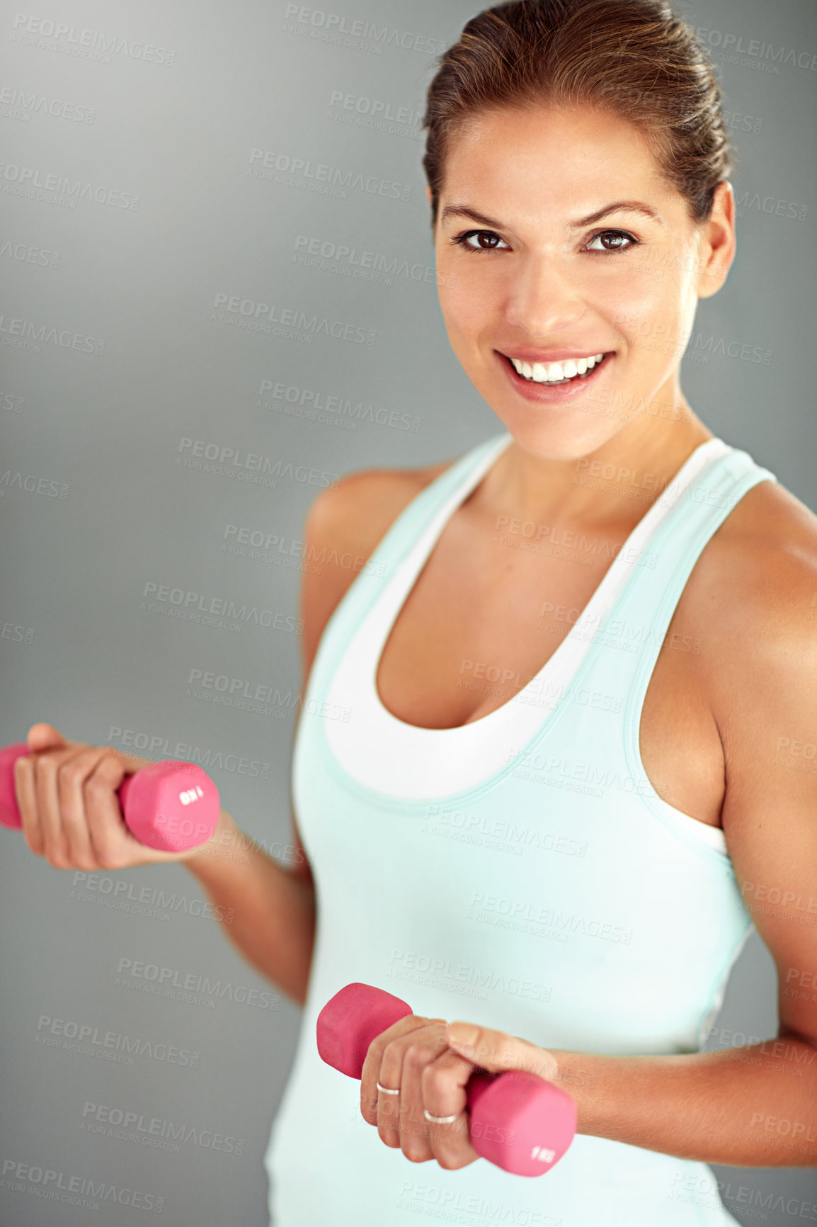 Buy stock photo Portrait, dumbbells and woman with fitness, balance and exercise on grey studio background. Face, healthy person and athlete with equipment, workout and training with wellness, energy and challenge