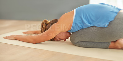 Buy stock photo Shot of a young woman doing yoga at home