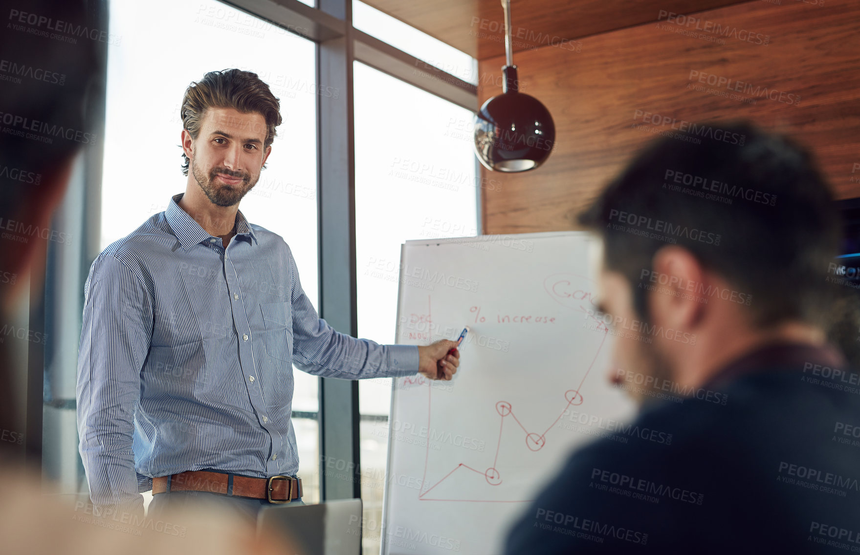 Buy stock photo Cropped shot of a young businessman giving a presentation