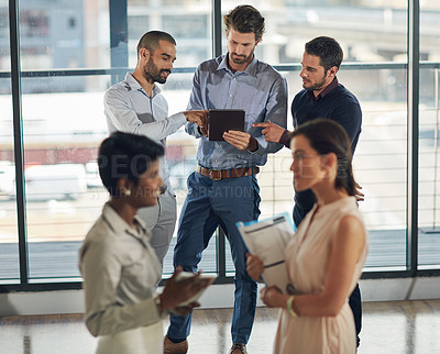 Buy stock photo Cropped shot of a group of businesspeople standing around in the office