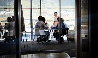 Buy stock photo Shot of a businesswoman giving a presentation to a group of colleagues in a boardroom