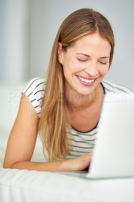 Buy stock photo Shot of a young woman browsing the internet at home 