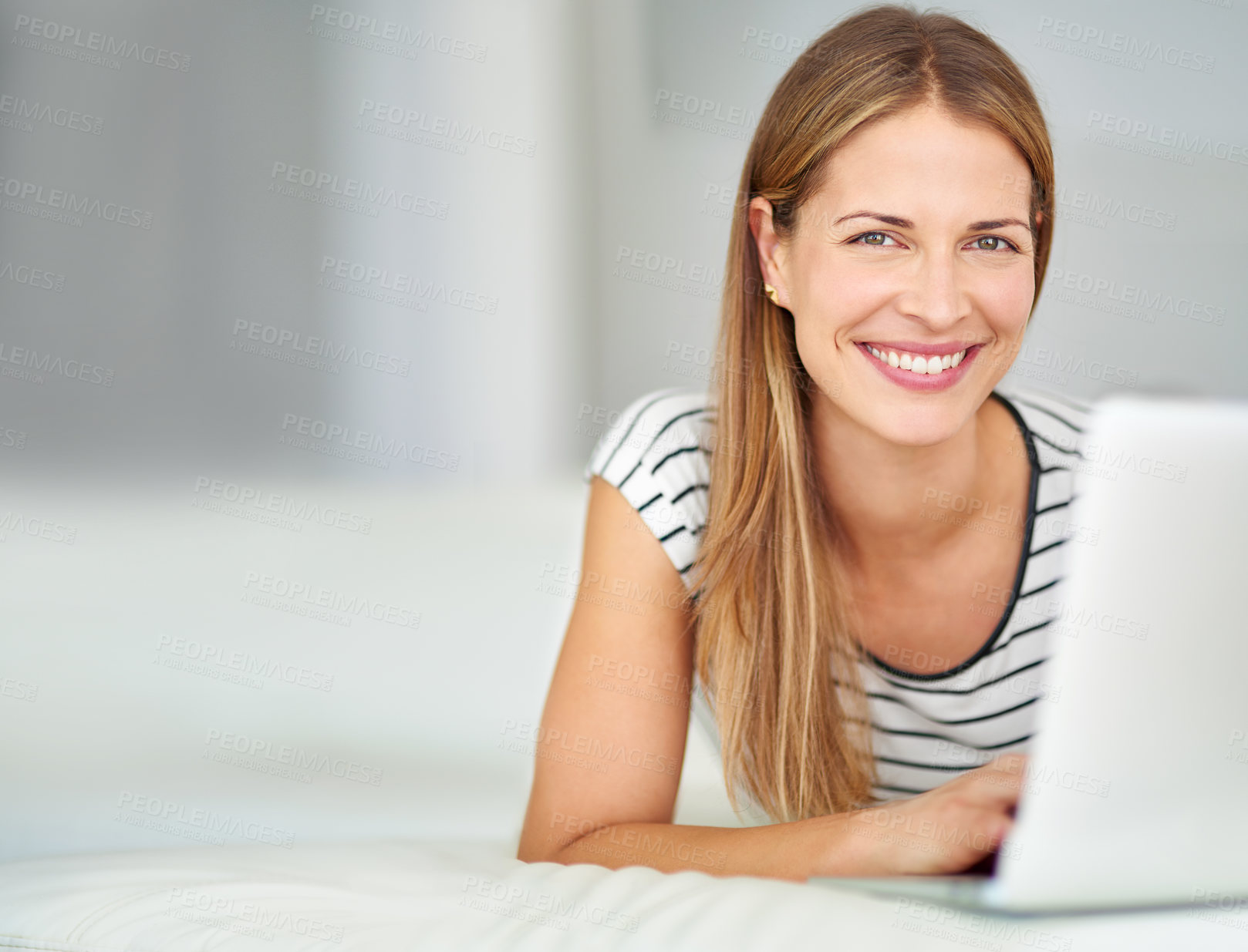 Buy stock photo Shot of a young woman browsing the internet at home 