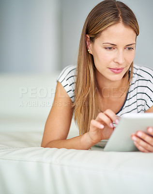 Buy stock photo Shot of a young woman browsing the internet at home