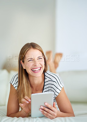 Buy stock photo Shot of a young woman browsing the internet at home 