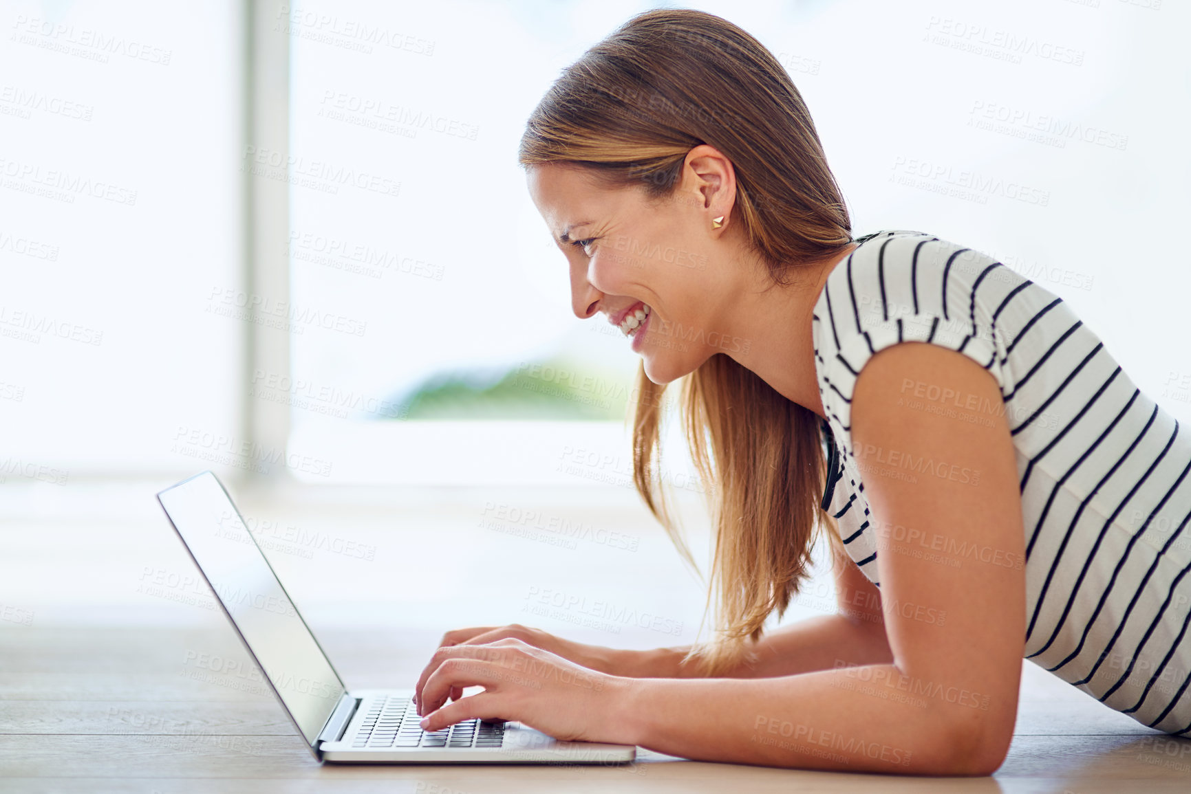 Buy stock photo Shot of a young woman browsing the internet at home 