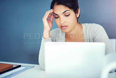Buy stock photo Shot of a businesswoman sitting with her hand on her head