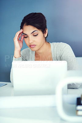 Buy stock photo Shot of a businesswoman sitting with her hand on her head