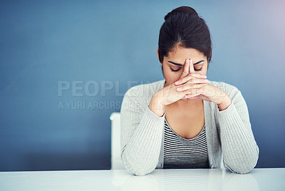 Buy stock photo Shot of a businesswoman looking stressed at her desk