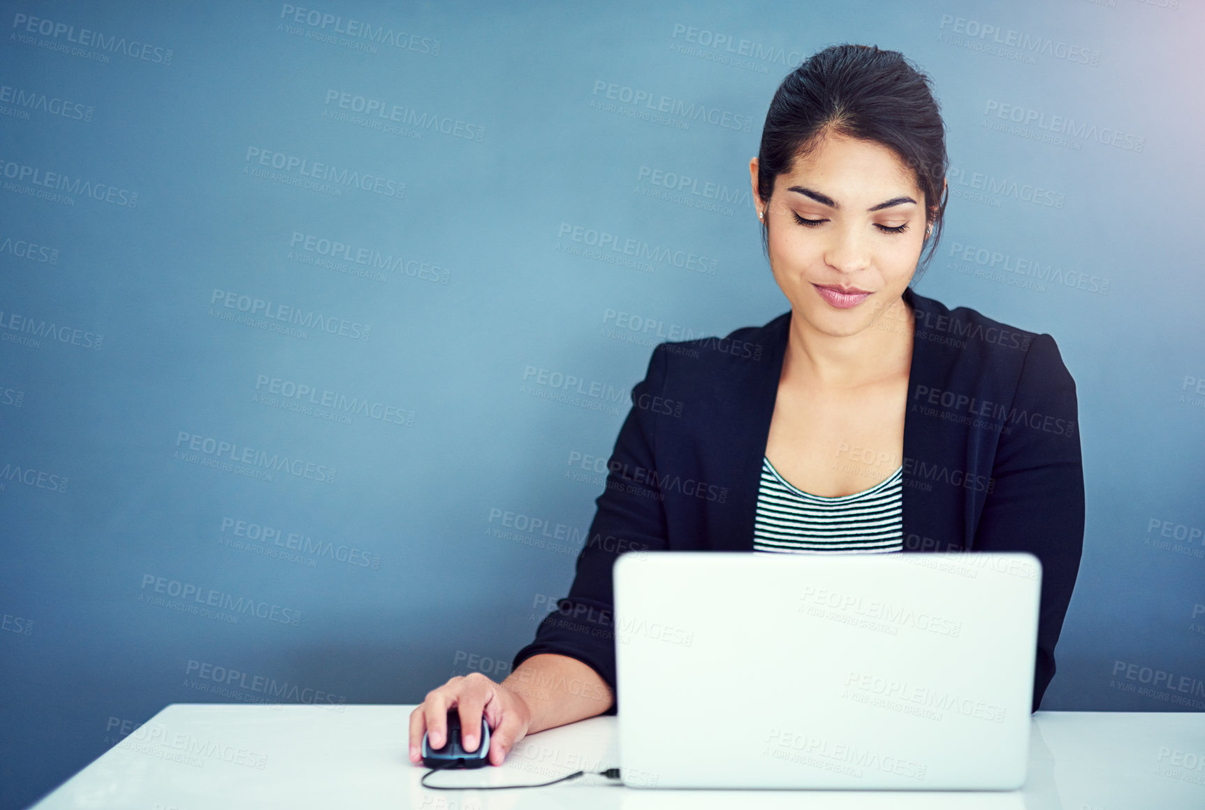 Buy stock photo Shot of a young businesswoman working at her desk