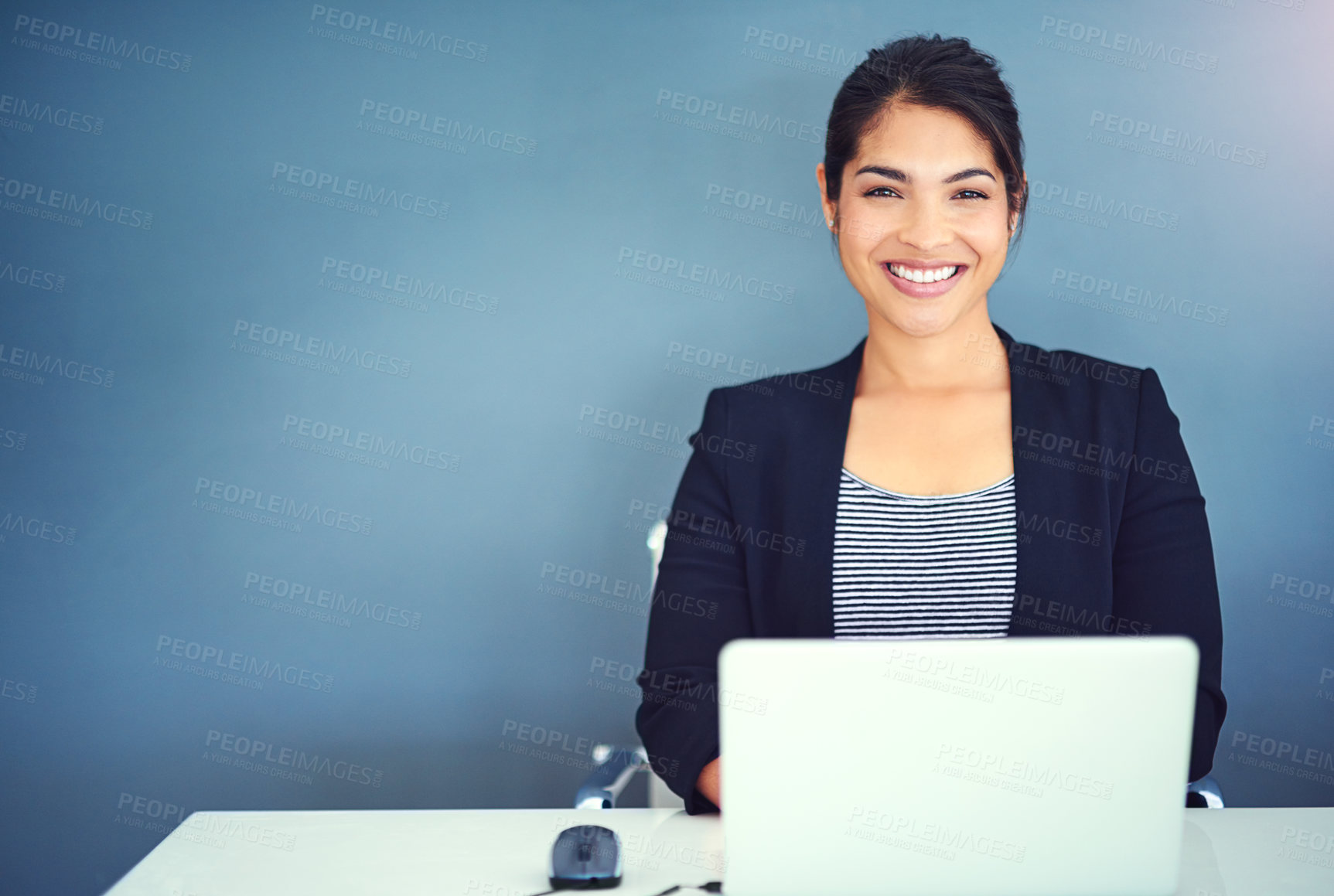 Buy stock photo Shot of a young businesswoman working at her desk