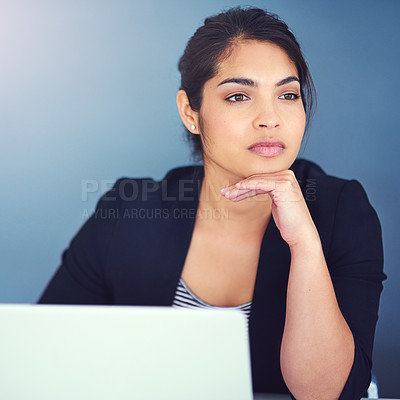 Buy stock photo Cropped shot of a young businesswoman looking distracted at her desk