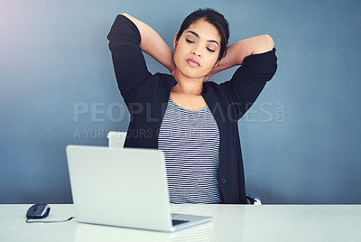 Buy stock photo Shot of a young businesswoman looking exhausted at her desk