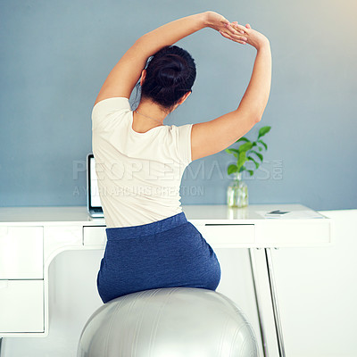 Buy stock photo Rearview shot of a young businesswoman stretching while working at home